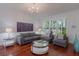 Well-lit living room featuring modern decor, hardwood floors and large windows at 920 Cool Springs Cir, Ocoee, FL 34761