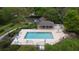 Aerial view of a community pool with lounge chairs and a covered seating area surrounded by lush landscaping at 920 Cool Springs Cir, Ocoee, FL 34761