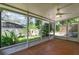 Screened porch with tile flooring looking out to lush landscaping at 920 Cool Springs Cir, Ocoee, FL 34761