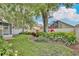 Large backyard with manicured lawn, lush plantings, privacy fence, and patio at 9521 Southern Garden Cir, Altamonte Springs, FL 32714