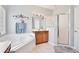 Bright bathroom featuring a soaking tub, glass shower, and wooden vanity at 9521 Southern Garden Cir, Altamonte Springs, FL 32714