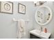Stylish half bathroom with decorative art, a modern sink, and updated fixtures at 9521 Southern Garden Cir, Altamonte Springs, FL 32714