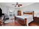Well lit bedroom with hardwood floors and fan, window and stylish furniture at 9521 Southern Garden Cir, Altamonte Springs, FL 32714