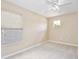 Empty bedroom with neutral carpet, a ceiling fan, and two windows at 9521 Southern Garden Cir, Altamonte Springs, FL 32714
