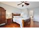 Spacious bedroom featuring hardwood floors, arched entryway, and ceiling fan at 9521 Southern Garden Cir, Altamonte Springs, FL 32714
