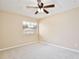 Well-lit bedroom with neutral carpet, a ceiling fan, and window at 9521 Southern Garden Cir, Altamonte Springs, FL 32714