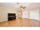 Large bonus room with wood-look floors, ceiling fan, and upright piano at 9521 Southern Garden Cir, Altamonte Springs, FL 32714