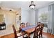 Elegant dining room featuring hardwood floors, a classic wooden table, and soft natural light at 9521 Southern Garden Cir, Altamonte Springs, FL 32714