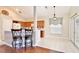 Bright kitchen with breakfast bar, oak cabinets, access to the dining area, and patio doors at 9521 Southern Garden Cir, Altamonte Springs, FL 32714