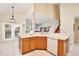 Bright, open-concept kitchen featuring a sink, dishwasher, and seamless flow to the breakfast area and staircase at 9521 Southern Garden Cir, Altamonte Springs, FL 32714