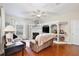 Comfortable living room featuring a fireplace, built-in shelving, and a large leather sofa under a ceiling fan at 9521 Southern Garden Cir, Altamonte Springs, FL 32714