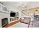 Spacious living area with hardwood floors, fireplace, TV, staircase, and dining room access at 9521 Southern Garden Cir, Altamonte Springs, FL 32714
