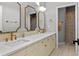 Bathroom with double vanity, white countertop, mosaic backsplash and decorative mirrors at 960 Brightwater Cir, Maitland, FL 32751