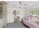 Cozy bedroom with plush daybed, whimsical decor, and a sunny window overlooking the neighborhood at 960 Brightwater Cir, Maitland, FL 32751