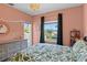 Bedroom boasting large bed with decorative pillows, ample sunlight, and elegant chandelier at 960 Brightwater Cir, Maitland, FL 32751