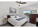 Comfortable bedroom featuring a bed with stylish bedding, ceiling fan, and natural light at 960 Brightwater Cir, Maitland, FL 32751