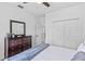Bedroom featuring a mirrored dresser with dark wood finish, white door, and double closets at 960 Brightwater Cir, Maitland, FL 32751