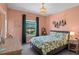 Bedroom features large bed with decorative pillows, ample sunlight, and beaded chandelier at 960 Brightwater Cir, Maitland, FL 32751