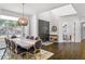 Bright dining room showcasing hardwood floors, a modern light fixture, and views of the front yard at 960 Brightwater Cir, Maitland, FL 32751