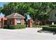 Gated community entrance with brick gatehouse, providing security and privacy at 960 Brightwater Cir, Maitland, FL 32751
