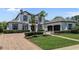 Elegant two-story home with lush landscaping, a paver driveway, and a three-car garage at 960 Brightwater Cir, Maitland, FL 32751