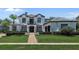 Stunning two-story home featuring a manicured lawn and a symmetrical facade with a central balcony at 960 Brightwater Cir, Maitland, FL 32751