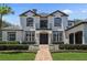 Beautiful two-story home boasts meticulous landscaping, a brick walkway, and elegant architectural details at 960 Brightwater Cir, Maitland, FL 32751