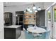 Bright kitchen features dark cabinets, stainless appliances, an island cooktop, and a dining area with backyard access at 960 Brightwater Cir, Maitland, FL 32751