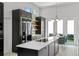 This kitchen offers modern cabinets, stainless steel appliances, a central island cooktop, and an adjacent dining area at 960 Brightwater Cir, Maitland, FL 32751