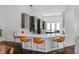 Sleek kitchen featuring a large island, barstool seating, stainless steel appliances, and pendant lighting at 960 Brightwater Cir, Maitland, FL 32751