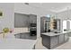 This stylish kitchen offers stainless steel appliances, custom cabinets, white countertops, and geometric tiled floors at 960 Brightwater Cir, Maitland, FL 32751