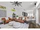 Open-concept living space with a large kitchen island, leather sofas, and modern decor at 960 Brightwater Cir, Maitland, FL 32751