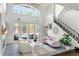 Bright living room offering high ceilings, access to the pool, and a modern staircase at 960 Brightwater Cir, Maitland, FL 32751