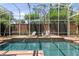 Inviting screened pool area with brick paver deck, lounge chairs, and privacy wall at 960 Brightwater Cir, Maitland, FL 32751