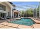 Gorgeous pool and patio with lounge seating, screened enclosure, and a view of the lush backyard at 960 Brightwater Cir, Maitland, FL 32751