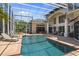 Stunning pool and patio with lounge seating, screened enclosure, and backyard views at 960 Brightwater Cir, Maitland, FL 32751