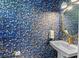 Chic powder room featuring designer wallpaper, a gold-framed mirror, and a modern pedestal sink with gold fixtures at 960 Brightwater Cir, Maitland, FL 32751