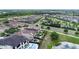 An aerial view of a residential area showing backyard pools, lakes and manicured lawns at 970 Golden Bear Dr, Reunion, FL 34747