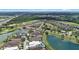 Aerial view of a luxury community featuring beautiful homes, a golf course, and serene lakes at 970 Golden Bear Dr, Reunion, FL 34747