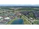 Aerial view showcasing a luxury neighborhood with community lakes, a golf course, and lush green surroundings at 970 Golden Bear Dr, Reunion, FL 34747