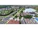 Scenic aerial view of a residential neighborhood with lush landscaping and a tranquil lake at 970 Golden Bear Dr, Reunion, FL 34747