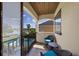 Relaxing balcony with seating overlooking pool and lake views at 970 Golden Bear Dr, Reunion, FL 34747