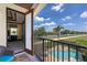 Inviting outdoor balcony with a view of the pool, blue skies and mature landscaping at 970 Golden Bear Dr, Reunion, FL 34747