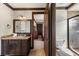 Bathroom featuring granite countertops, white cabinets, separate shower and water closet at 970 Golden Bear Dr, Reunion, FL 34747