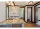 Large bathroom with double vanity sinks, granite countertop and dark wood trim at 970 Golden Bear Dr, Reunion, FL 34747