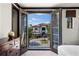 Bedroom with french doors with a view of the exterior elevation and landscaping at 970 Golden Bear Dr, Reunion, FL 34747