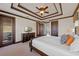 Nicely appointed bedroom with coffered ceilings, dark wood trim, a ceiling fan, and access to a private balcony at 970 Golden Bear Dr, Reunion, FL 34747