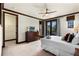 Spacious bedroom with ceiling fan, french doors, and a walk-in closet for ample storage at 970 Golden Bear Dr, Reunion, FL 34747
