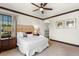 Well-lit bedroom with ceiling fan, comfortable bed, and stylish decor for a relaxing atmosphere at 970 Golden Bear Dr, Reunion, FL 34747