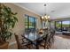 Beautiful dining room with dark wood table and view of the outdoor living area at 970 Golden Bear Dr, Reunion, FL 34747
